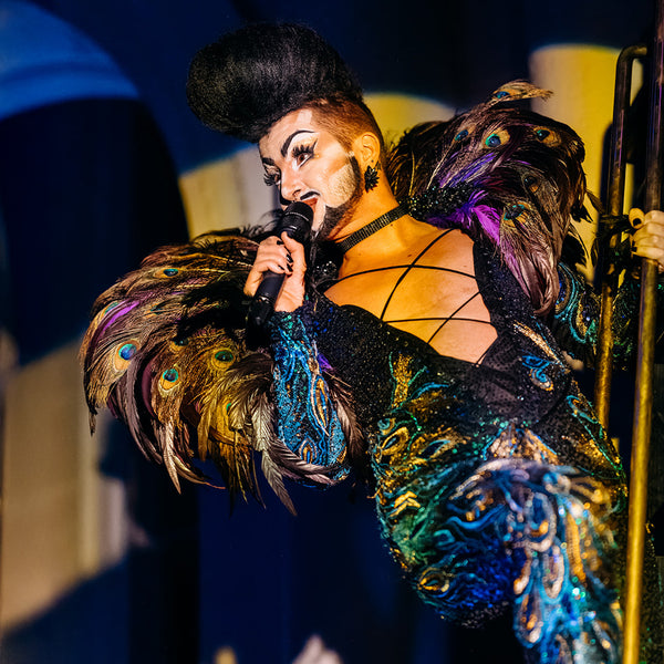 Colossal Circus Wellington live performance  costume peacock feathers