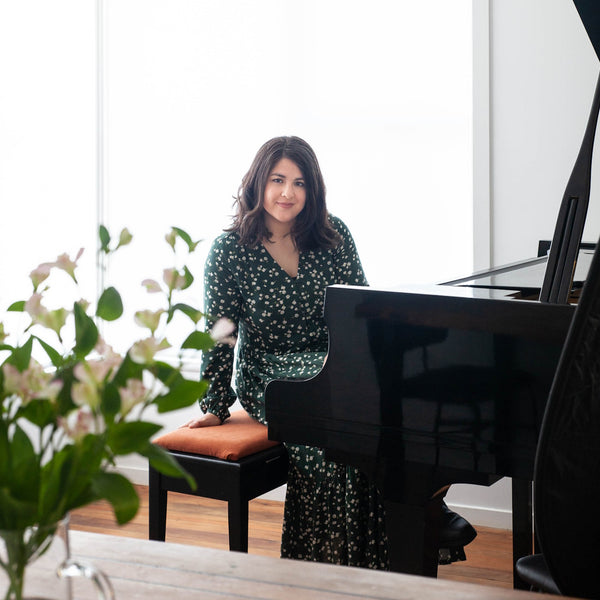 Natalie Meszaros sitting at piano
