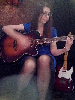 Henrieta playing guitar