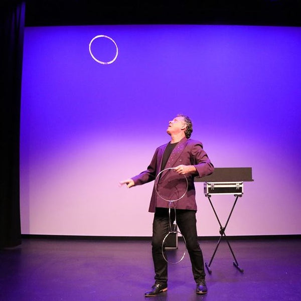 Auckland magician Brent McLeod onstage with rings