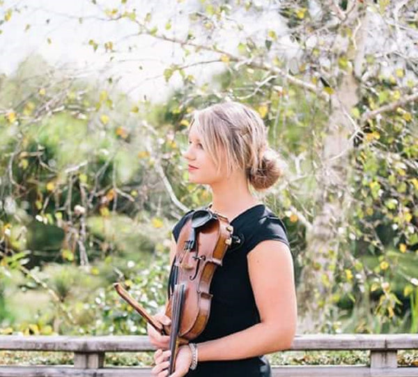Natasha Sennee outdoors with violin