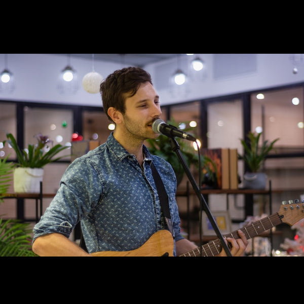 Live performance Ant Tarrant playing guitar and singing