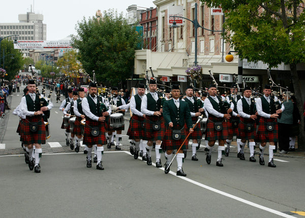 Auckland and District pipe band marching down street