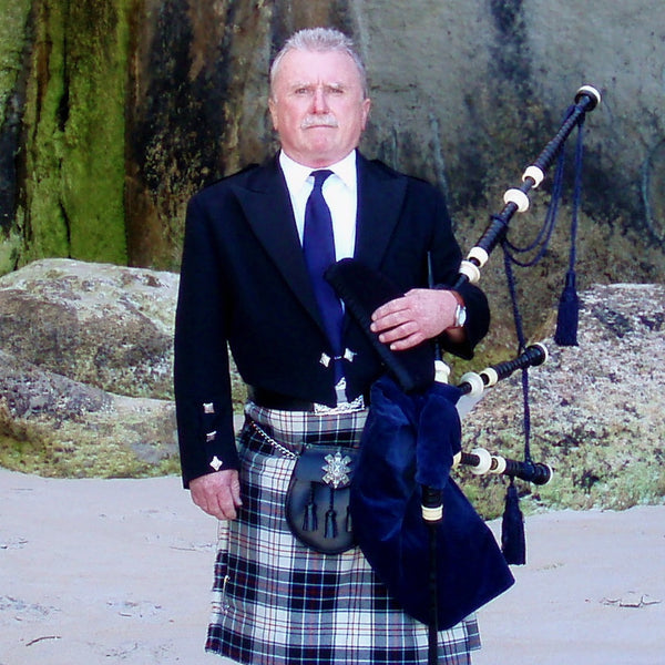 Bill Swift in blue kilt with bagpipes