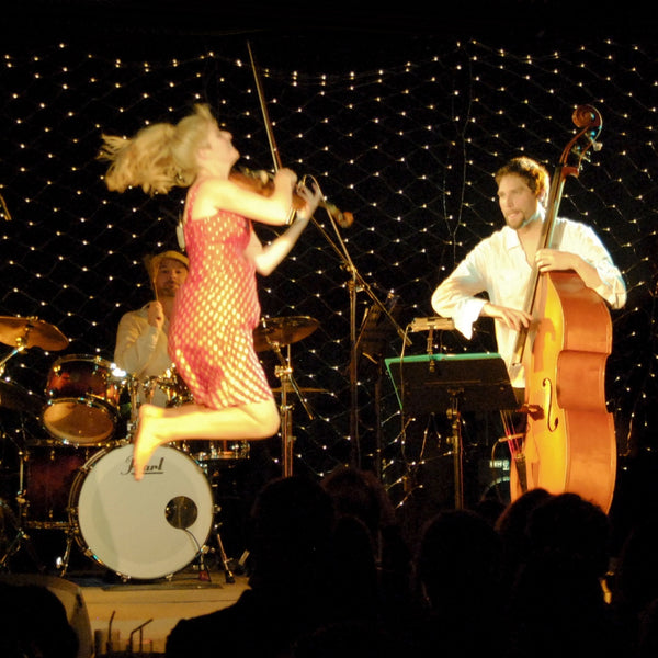 Fiona Pears midair in one of her violin performances