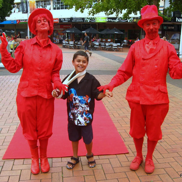 Free Lunch Hamilton red characters with young child at event