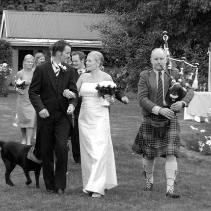 Graeme Glass piper Queenstown walking with bridal party at wedding