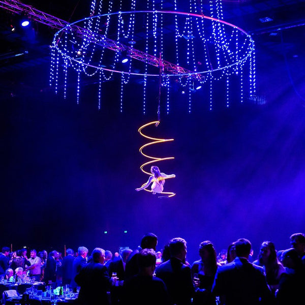 corporate event with aerial display from Wellington performer Imogen Stone in gold coil